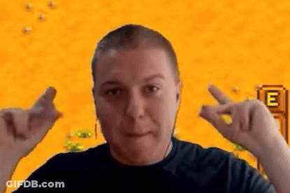 A Man Is Making A Heart Shape With His Hands In Front Of A Video Game Screen . GIF