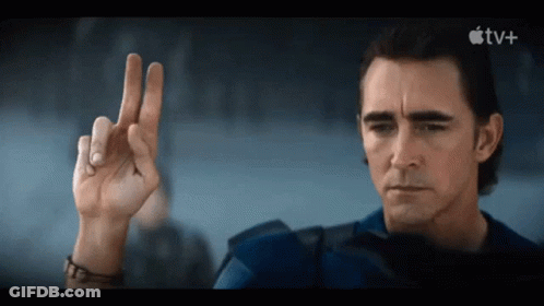 A Man Is Making A Peace Sign In Front Of An Apple Tv Logo GIF
