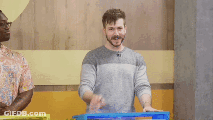A Man Is Making A Silence Gesture With His Finger On His Lips GIF