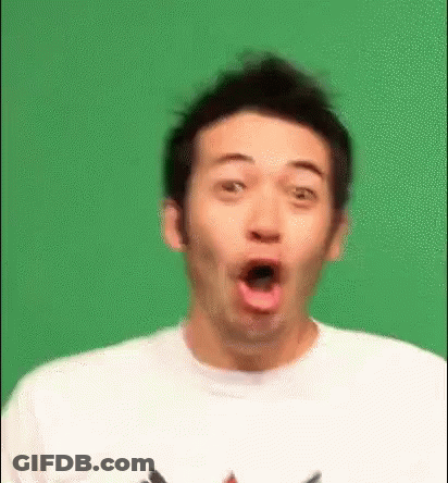 A Man Is Making A Surprised Face In Front Of A Green Background . GIF