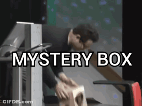 A Man Is Opening A Mystery Box In Front Of A Monitor GIF