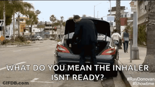 A Man Is Opening The Trunk Of A Car And Says What Do You Mean The Inhaler Isnt Ready . GIF
