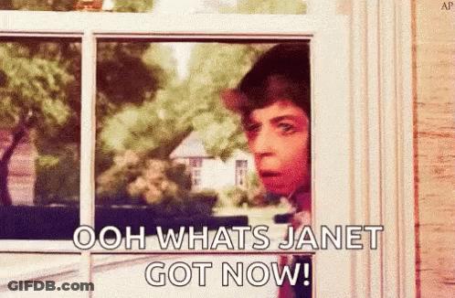 A Man Is Peeking Out Of A Window And Saying `` Ooh Whats Janet Got Now '' . GIF