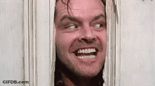 A Man Is Peeking Through A Door With His Mouth Open And Making A Funny Face . GIF