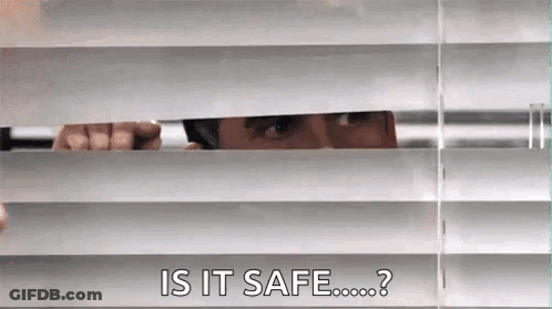 A Man Is Peeking Through The Blinds Of A Window And Asking If It Is Safe . GIF