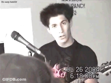 Man Playing Guitar And Singing Into Microphone GIF