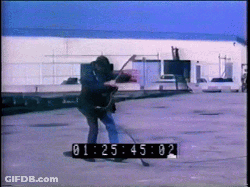 A Man Is Playing A Guitar In A Parking Lot With A Timer That Says 01:25:02 GIF