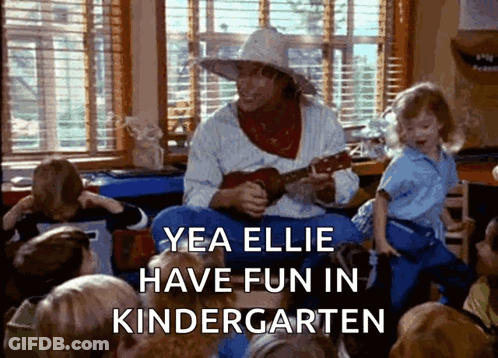 A Man Is Playing A Guitar In Front Of A Group Of Children With The Caption Yea Ellie Have Fun In Kindergarten Written Be GIF