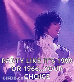 A Man Is Playing A Guitar On A Stage . GIF