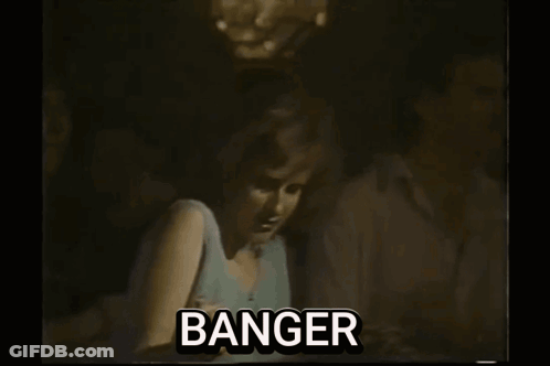 A Man Is Playing A Guitar On Stage In A Black And White Photo With The Word Banger . GIF