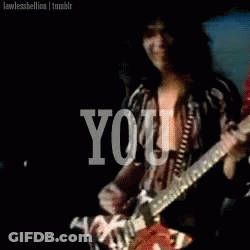 A Man Is Playing A Guitar With The Word You Behind Him GIF