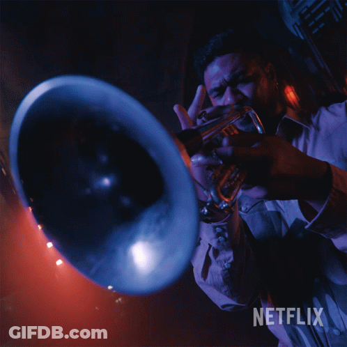 A Man Is Playing A Trumpet With A Netflix Logo In The Background GIF