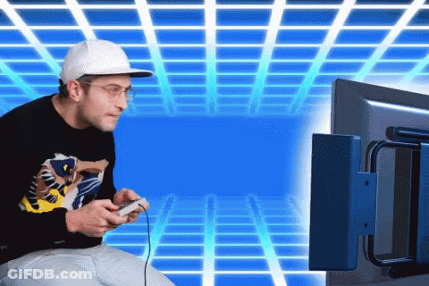 A Man Is Playing A Video Game With A Controller GIF