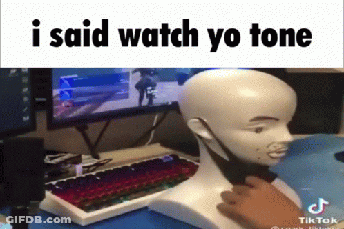 A Man Is Playing A Video Game With A Mannequin Head In Front Of A Computer Monitor And Keyboard GIF