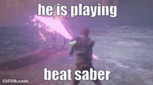 A Man Is Playing A Video Game With A Purple Light Saber GIF
