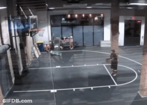 A Man Is Playing Basketball On A Court With A Basketball Hoop That Has The Number 7 On It GIF