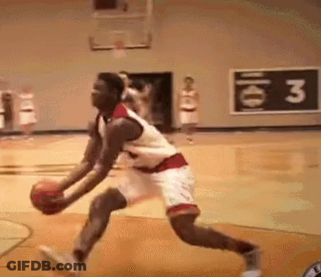 A Man Is Playing Basketball On A Court With A Sign That Says ' 3 ' On It . GIF