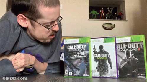 A Man Is Playing Call Of Duty Black Ops Ii On Xbox 360 GIF