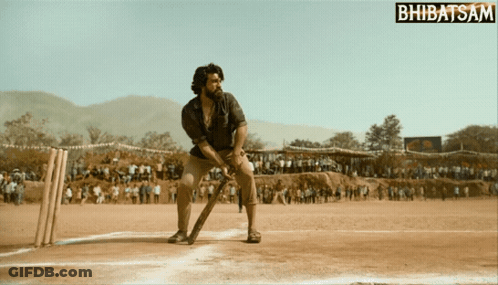 A Man Is Playing Cricket On A Field With A Bhbatsam Logo In The Corner GIF