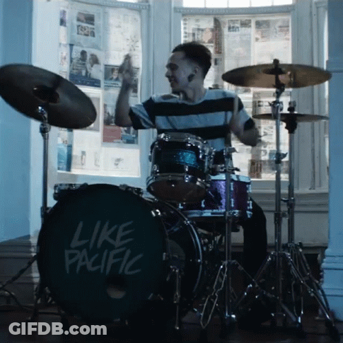 A Man Is Playing Drums With A Drum Set That Says Like Pacific GIF