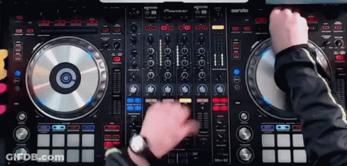 A Man Is Playing Music On A Pioneer Dj Controller GIF