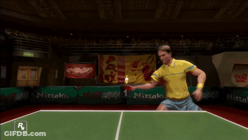A Man Is Playing Ping Pong In A Video Game With A Nitto Logo In The Background GIF