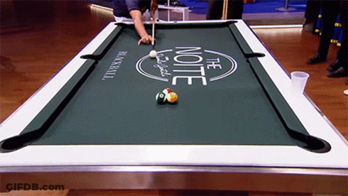 A Man Is Playing Pool On A Table That Says The Note GIF
