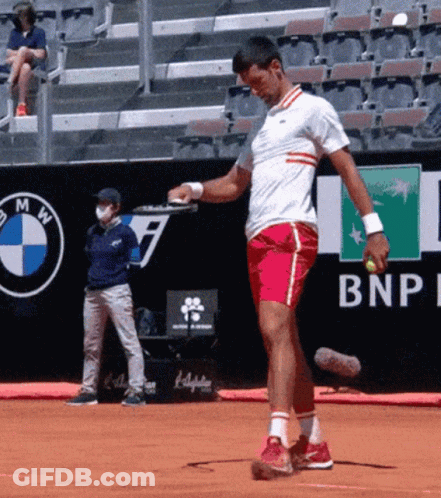 A Man Is Playing Tennis In Front Of A Bnp Ad GIF