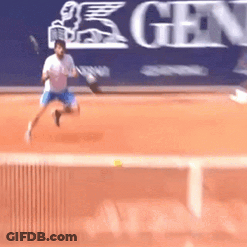 A Man Is Playing Tennis On A Court In Front Of A Sign That Says Gen GIF