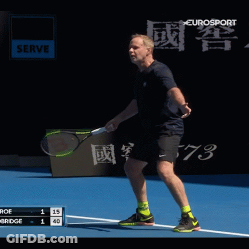 A Man Is Playing Tennis On A Court With A Eurosport Sign In The Background GIF