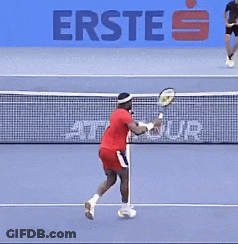 A Man Is Playing Tennis On A Court With A Sign That Says Erste On It GIF