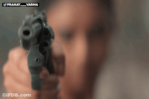 A Man Is Pointing A Gun At The Camera With The Words Pranay_varma On The Bottom GIF