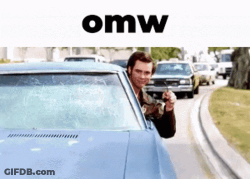 A Man Is Pointing A Gun Out Of The Window Of A Car With The Word Omw Below Him GIF
