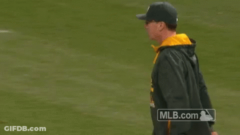 A Man Is Pointing At Something On A Baseball Field With A Mlb.com Logo In The Background GIF