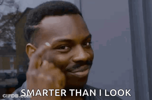 A Man Is Pointing His Finger At His Forehead And Saying Smarter Than I Look GIF