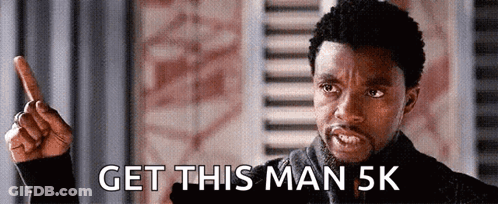 A Man Is Pointing Up And Saying Get This Man 5K GIF