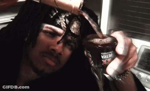 A Man Is Pouring A Drink From A Bottle That Says Ultra X GIF