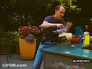 A Man Is Pouring A Drink From A Mixer On A Msnbc Table GIF