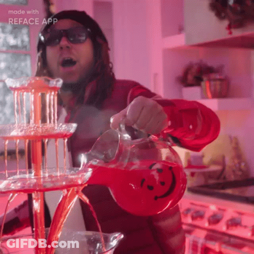 A Man Is Pouring A Red Drink Into A Pitcher With A Smiley Face On It GIF