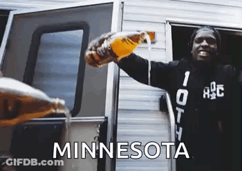 A Man Is Pouring Beer From A Bottle Into A Camper Door . GIF