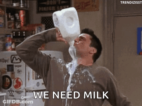 A Man Is Pouring Milk From A Gallon Into His Mouth . GIF