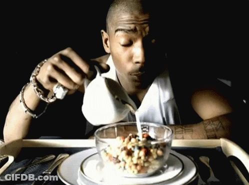 A Man Is Pouring Milk Into A Bowl Of Cereal With Roman Numerals On His Arm GIF