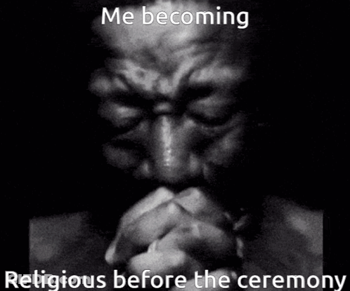 A Man Is Praying In A Black And White Photo . GIF