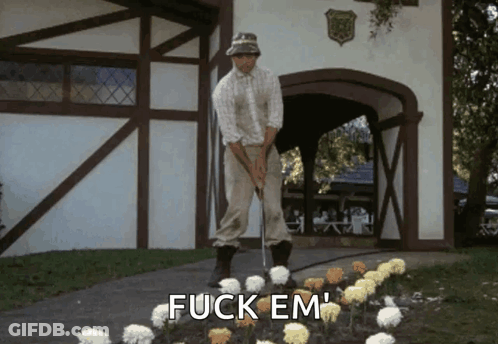 A Man Is Putting A Golf Ball In A Garden With The Words Fuck Em Written On The Ground GIF
