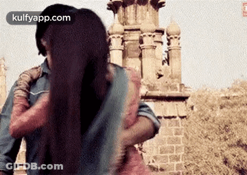 A Man Is Putting His Arm Around A Woman 'S Shoulder . GIF