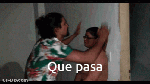 A Man Is Putting His Hand On Another Man 'S Head With The Words Que Pasa Written Above Him GIF