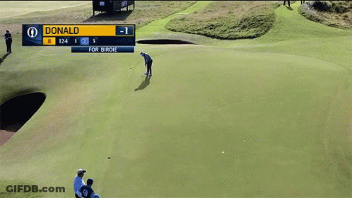 A Man Is Putting On A Golf Course With A Scoreboard That Says 1 2 3 GIF