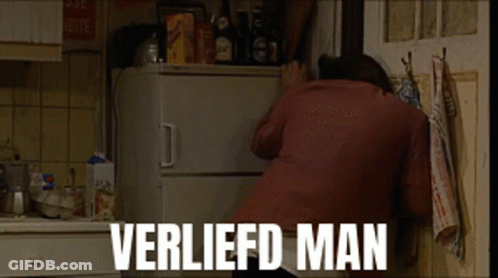 A Man Is Reaching Into A Refrigerator With The Words Verliefd Man Written On The Bottom GIF