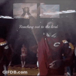 A Man Is Reaching Out To The Lord In A Crowd GIF