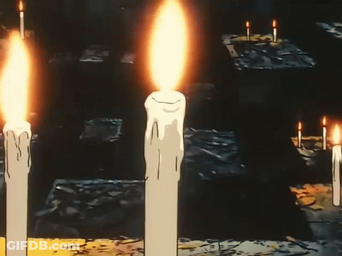 A Man Is Reading A Book With A Cross On His Forehead GIF